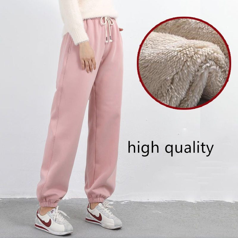 Pink sweatpants worn by a person with a close-up of the fabric texture and 'high quality' text.