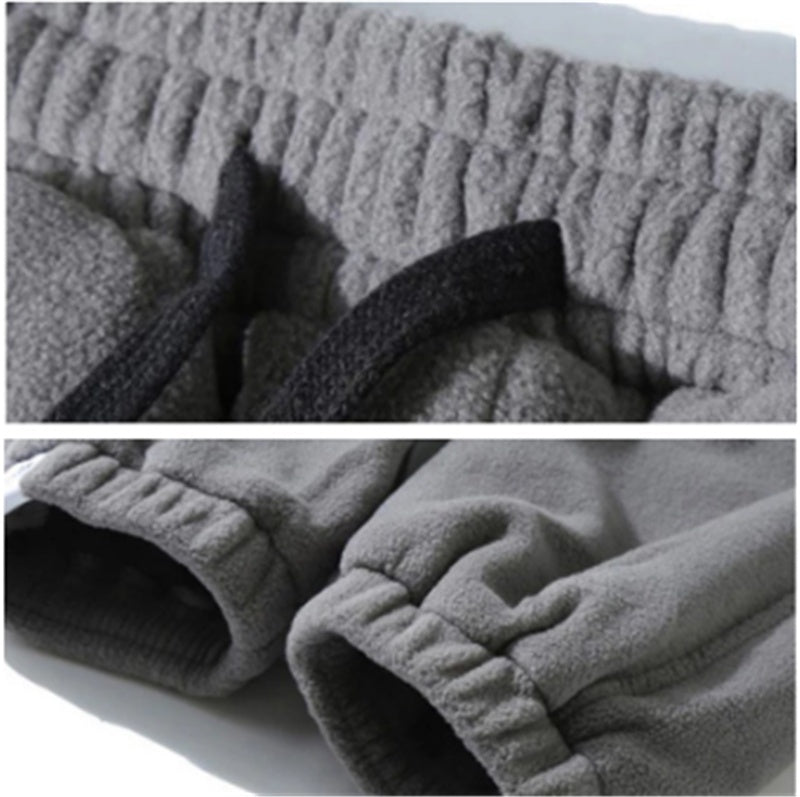 Close-up of gray fleece pants with ribbed texture on a white background