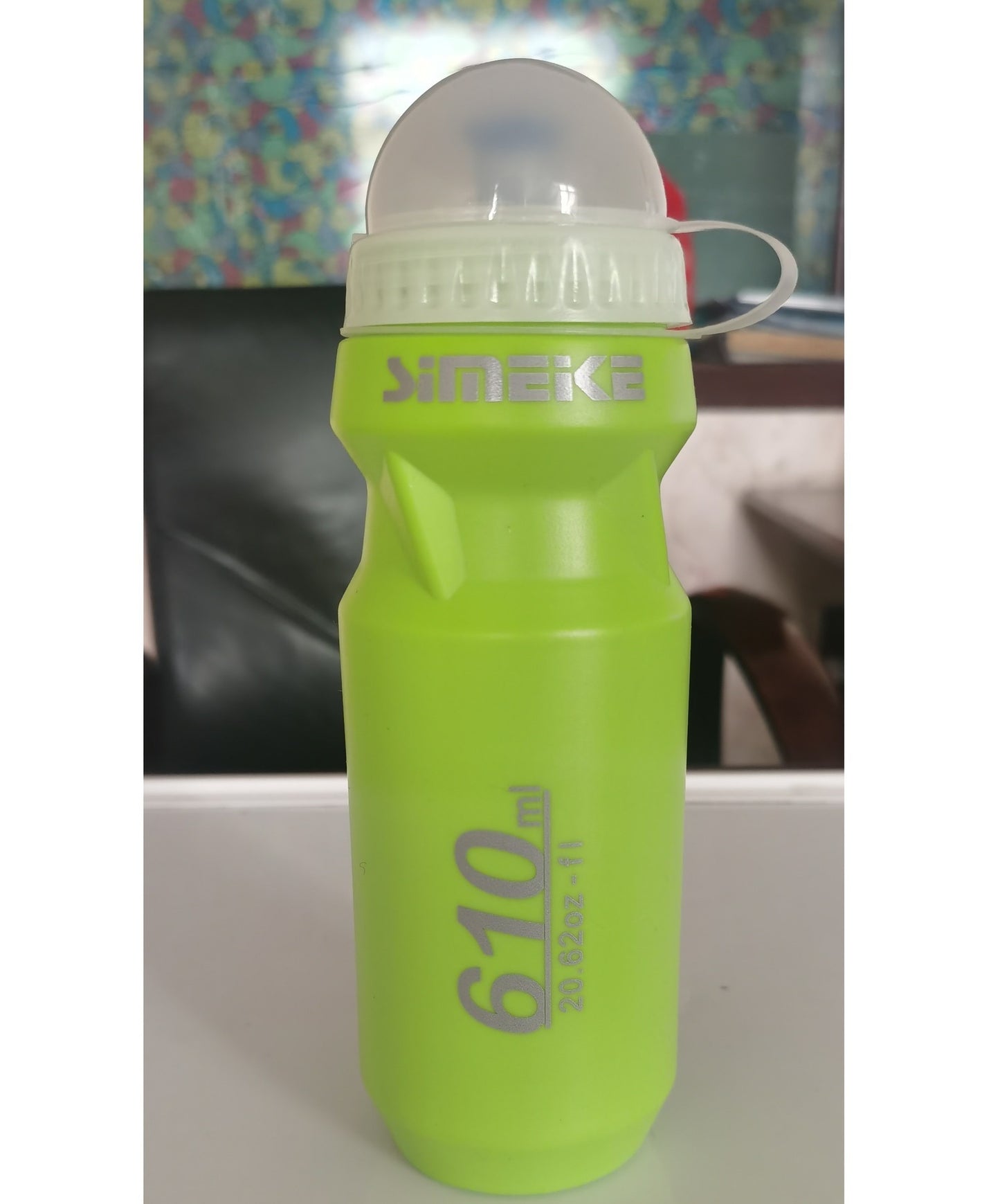 Green water bottle with SIMEK branding on a white surface