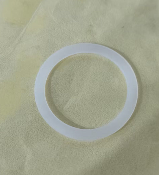 Clear silicone washer on a beige fabric background