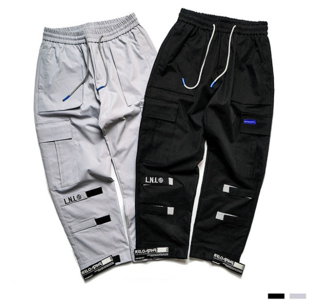 Black and gray cargo pants with visible branding on a white background