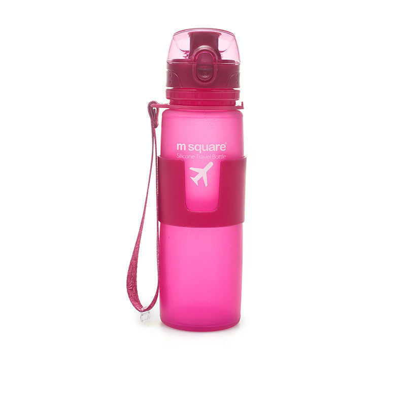 Pink water bottle with a strap on a white background