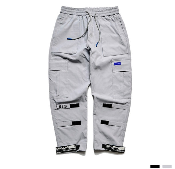 Gray cargo pants with multiple pockets and brand labels on a white background