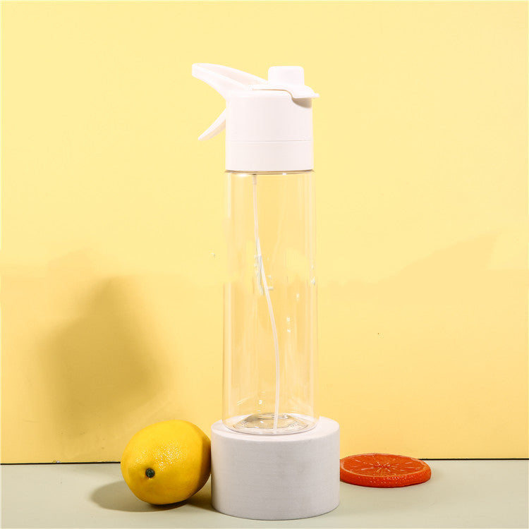 Clear spray bottle with white top on a yellow background