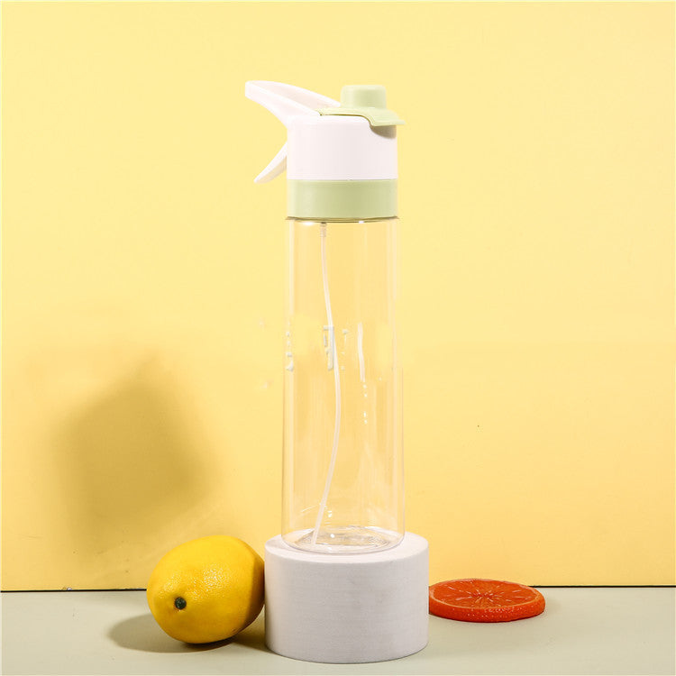 Clear spray bottle with white top and base on a yellow background