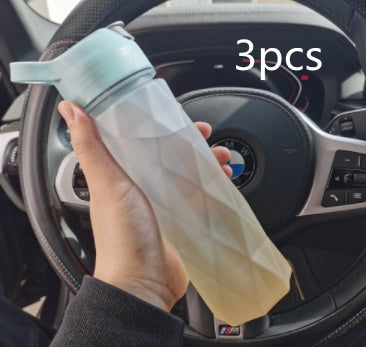 Hand holding a transparent silicone bag with a steering wheel and car interior in the background