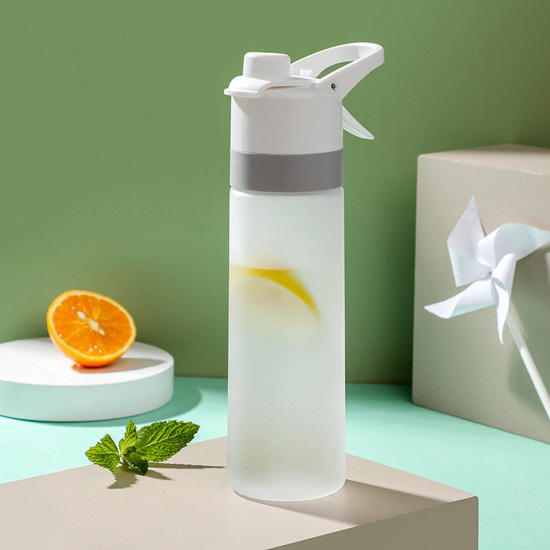 Clear water bottle with lemon and mint on a green background