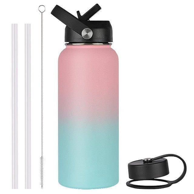 Gradient pink to blue water bottle with black lid and straw on a white background