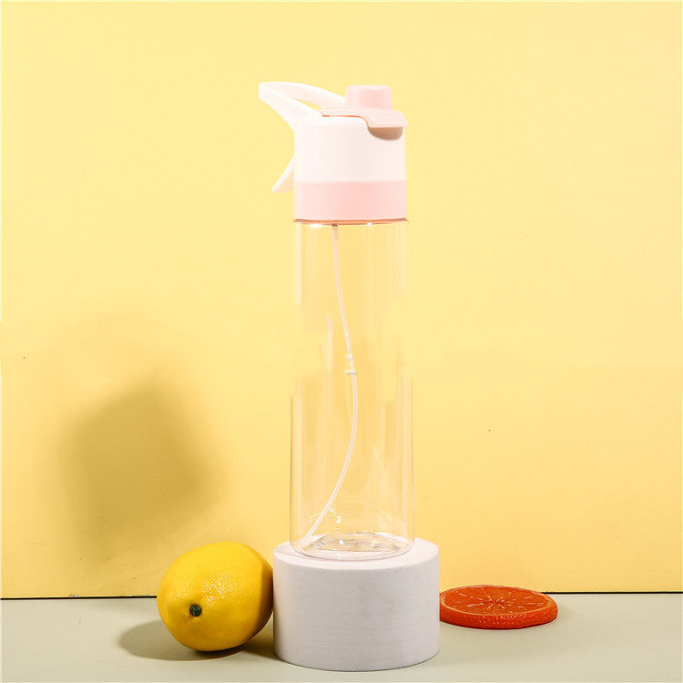 Clear glass water bottle with pink cap and white base on a yellow background